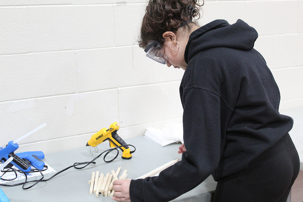 a student doing wood working at skills