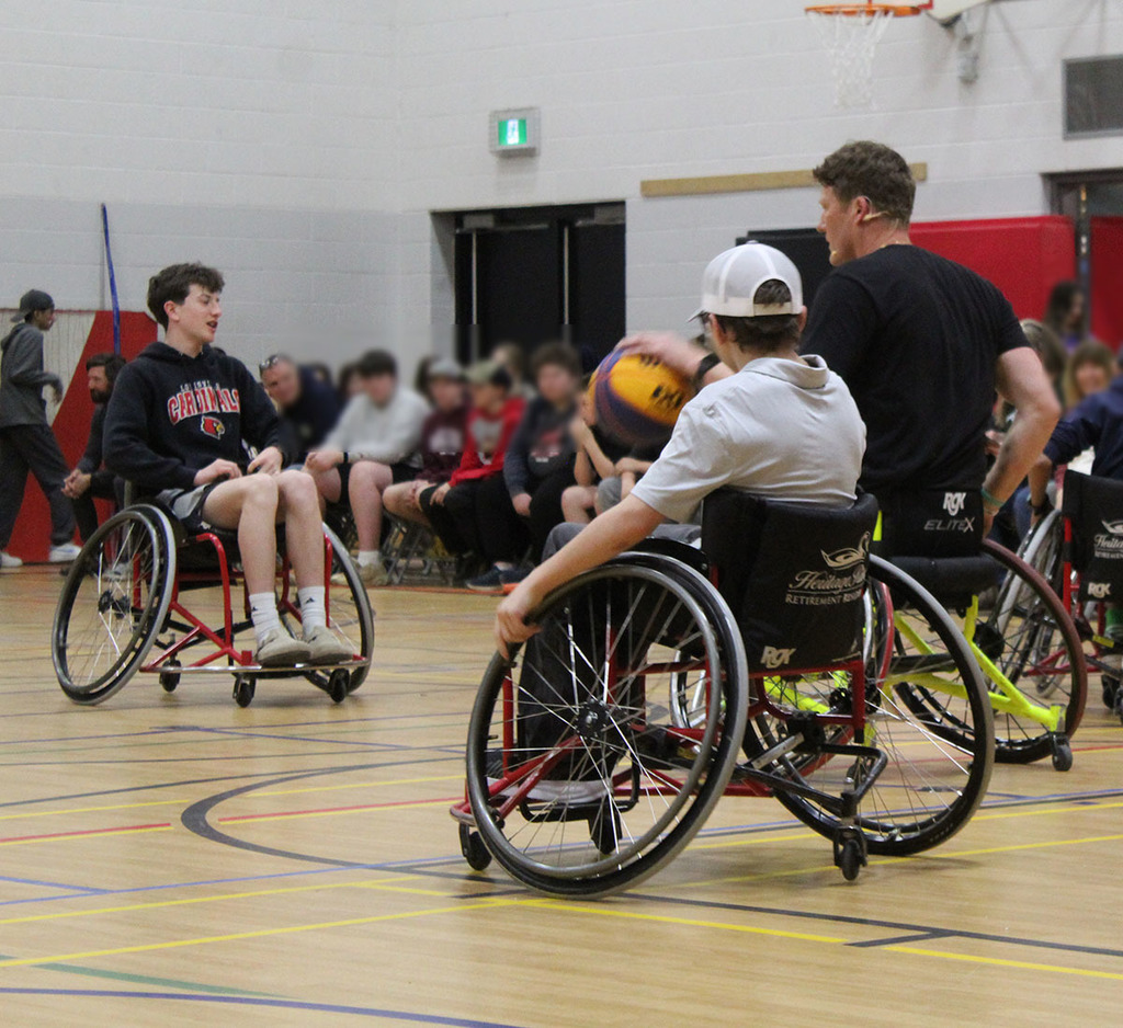 students playing wheelchair basketball with patrick anderson