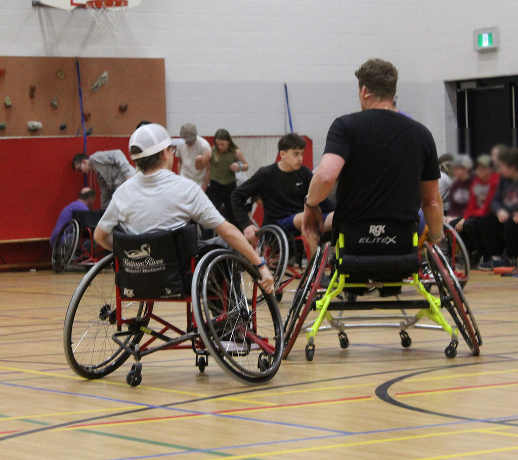 students playing wheelchair basketball with patrick anderson