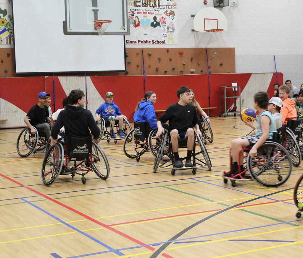 students playing wheelchair basketball with patrick anderson