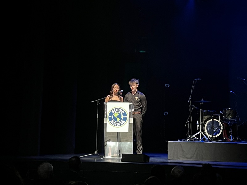Two students talking on stage at the Evolve gala