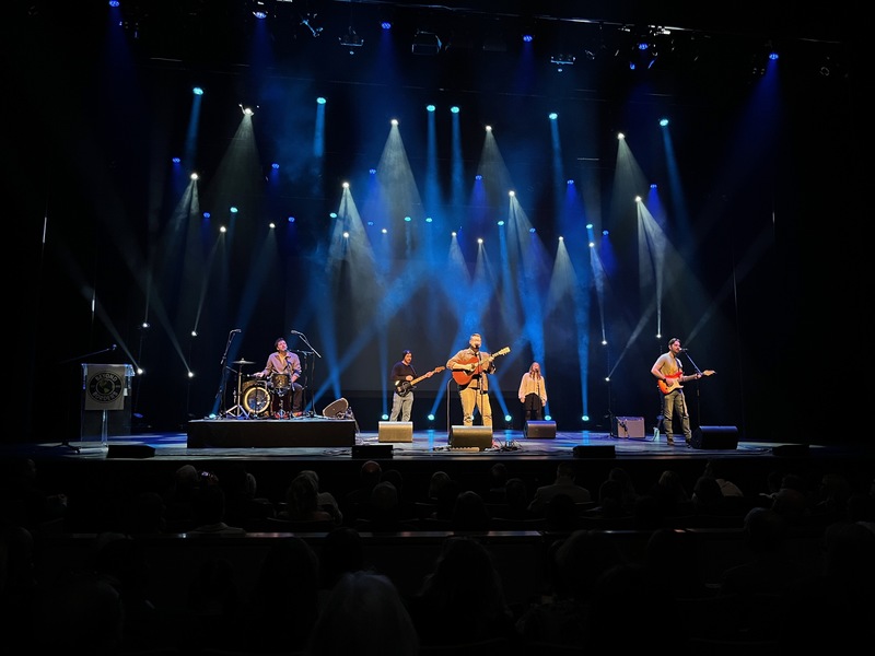 A band playing on stage at the River Run Centre