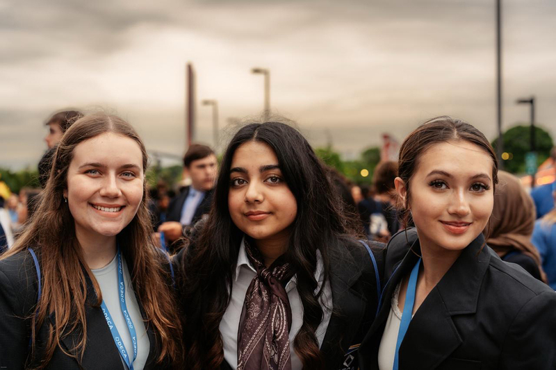 3 students pose for a photograph
