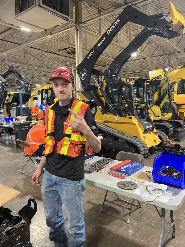 A student with heavy equipment at skills
