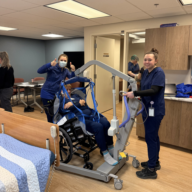 PSW students pose for a photo in a healthcare setting.