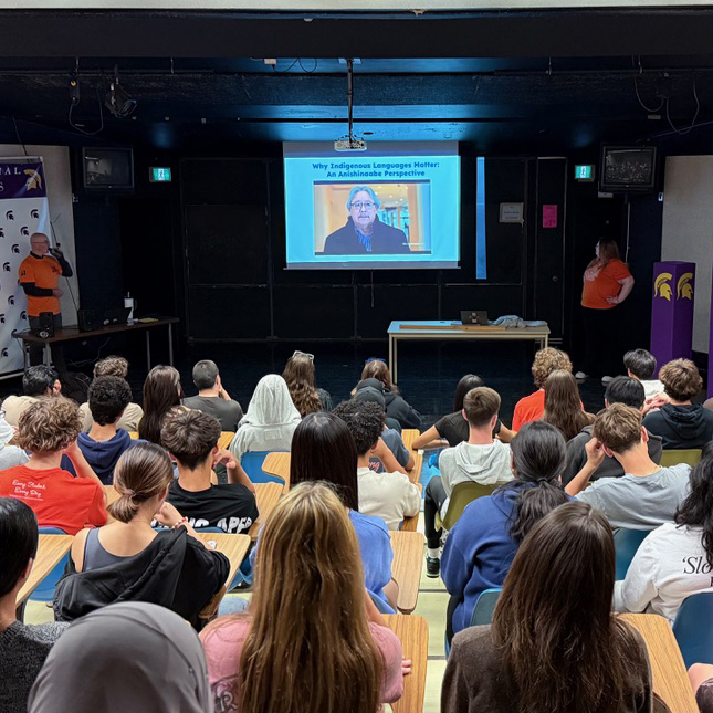 Students watch a lecture in a classroom