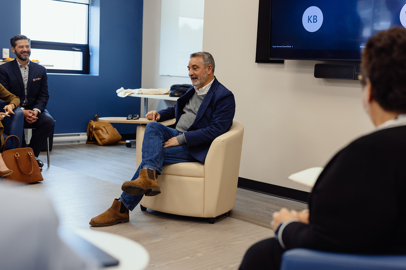 Education Minister Calandra sitting in a chair.