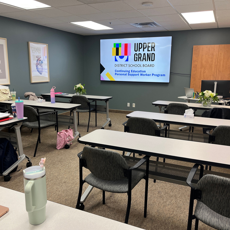 An image of a classroom with desks.