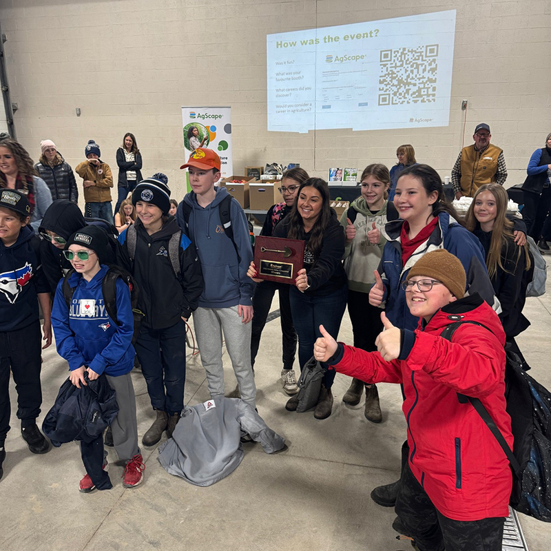 Students hold a plaque